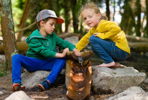 Two children playing with water